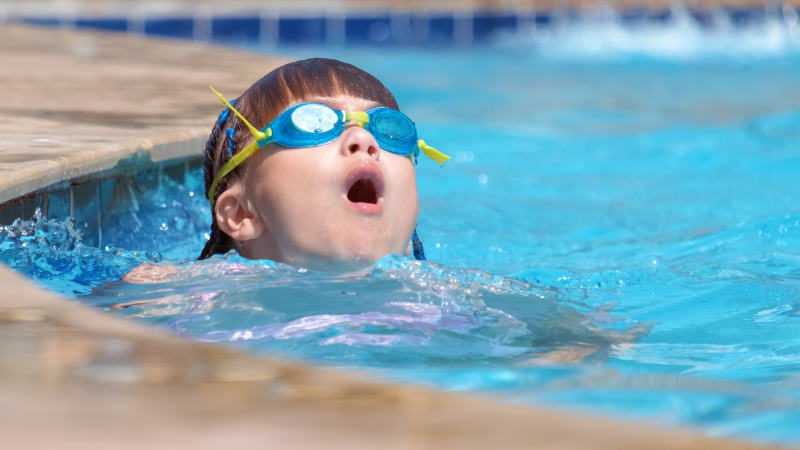 Image of a young kid taking swimming lessons in a pool in PA