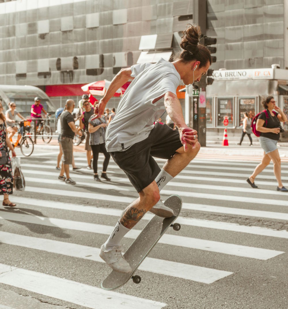 A guy skateboarding in downtown PA